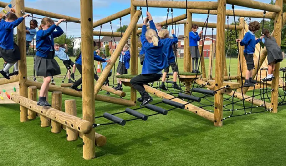 Children playing on colorful school playground equipments for learning and physical growth.